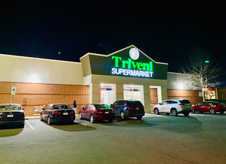 Vehicle Parking view of Triveni Supermarket, an Indian Restaurant in Pineville.