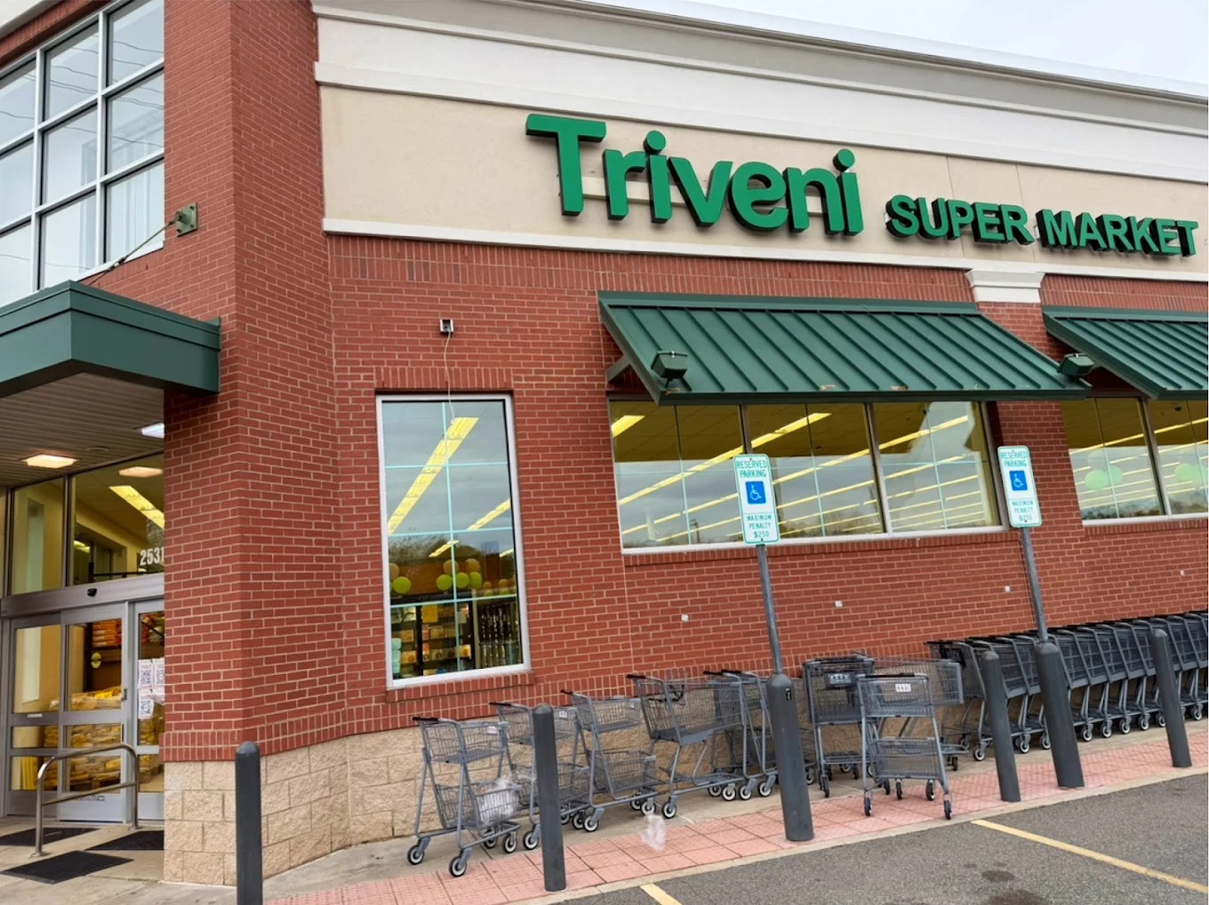 Set of stainless steel shopping cart trolleys at Triveni Supermarket, an Indian waxhaw restaurant.